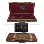 JAMES PURDEY & SONS A BRASS-CORNERED OAK AND LEATHER DOUBLE GUNCASE, fitted for 28in. barrels, the