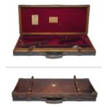 JAMES PURDEY & SONS A BRASS-CORNERED OAK AND LEATHER DOUBLE GUNCASE, fitted for 29in. 12-bore side