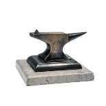 A MINIATURE GUNMAKER'S ANVIL, measuring approx. 6in. x 5in. x 4in., mounted on a marble plinth