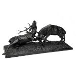 A BRONZE SCULPTURE OF TWO RUTTING RED STAGS, measuring approx. 9in. x 22in. x 9in.