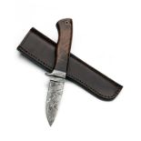 A DAMASCUS CLIP-POINT KNIFE, 3 3/4in. blade, damascus guard, walnut one-piece handle with lanyard