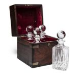 A VINTAGE CASED DECANTER SET, four 750ml glass bottles, with brass-bound mahogany case, brass