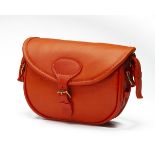 AN UNUSED ORANGE LEATHER SUEDE-LINED MEDIUM CARTRIDGE BAG, with canvas and leather shoulder strap,