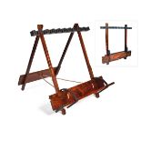 A TEAK PORTABLE FOLDING 'THE COLONIAL' GUN RACK WITH LEATHER LINING AND BRASS MOUNTS, suitable for