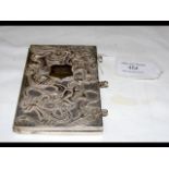 A Chinese white metal purse with relief Dragon dec