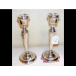 A pair of 23cm silver candlesticks with beaded dec