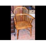An antique stick back country armchair with crinol