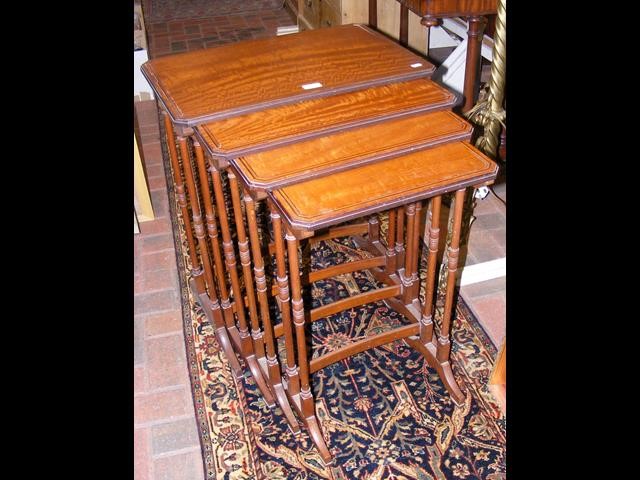 A nest of four Edwardian satinwood tables with tur