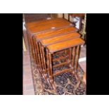 A nest of four Edwardian satinwood tables with tur