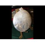 A decorative carved oyster shell - depicting The L