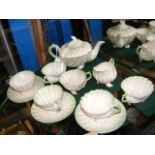 A Belleek teaset, comprising a teapot, cups, sauce