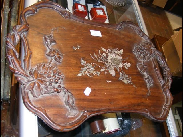 An oriental hardwood two handled tray with floral