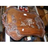 An oriental hardwood two handled tray with floral