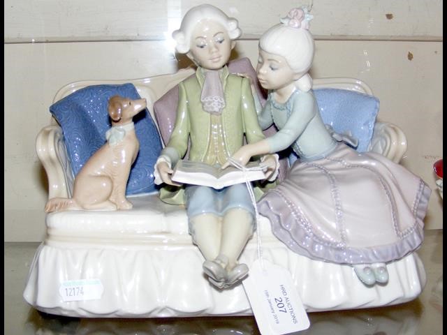 A Lladro figural group of boy, girl and dog on settee