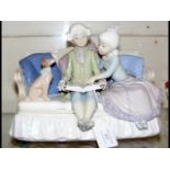 A Lladro figural group of boy, girl and dog on settee