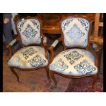 A pair of antique French armchairs with cabriole fro