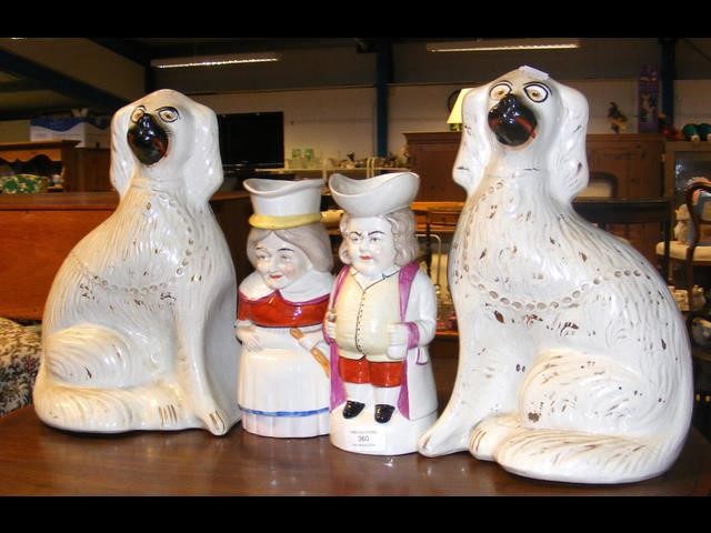 A pair of Staffordshire dog ornaments and two Toby