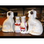 A pair of Staffordshire dog ornaments and two Toby