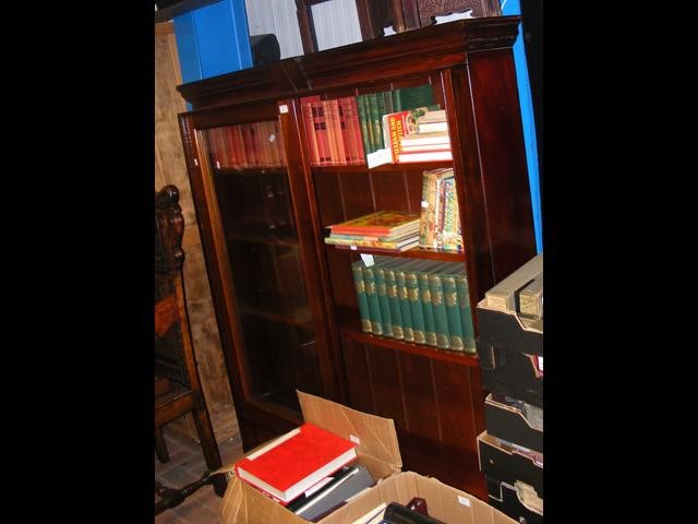 A mahogany bookcase with sliding glazed doors