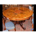 A circular antique breakfast table with brass and