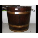 An old metal bound wooden bucket with handles to s