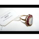 A gold moonstone and ruby ring