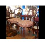 A pair of antique dining chairs with cabriole supp