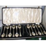 A set of twelve silver teaspoons and sugar tongs