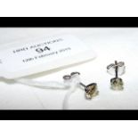 A pair of diamond stud earrings in 18ct white gold