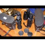 A pair of binoculars in carrying case and one othe
