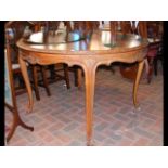 A 120cm diameter circular walnut dining table on c