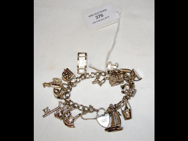 A silver charm bracelet with sixteen charms