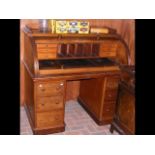 A Victorian mahogany cylinder writing desk with pu