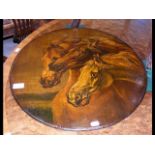 A 50cm diameter painting on slate of horses