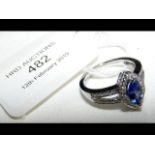 An 18ct white gold tanzanite and diamond cluster r