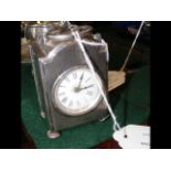 A silver cased travelling clock - 8cm high