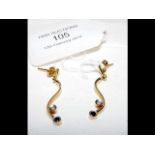 A pair of decorative sapphire and diamond gold ear