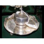 A silver Victorian inkwell with cherub to the top