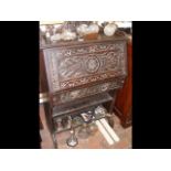 A Victorian carved oak desk with single drawer
