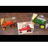 An Ertl die-cast tractor, together with two others