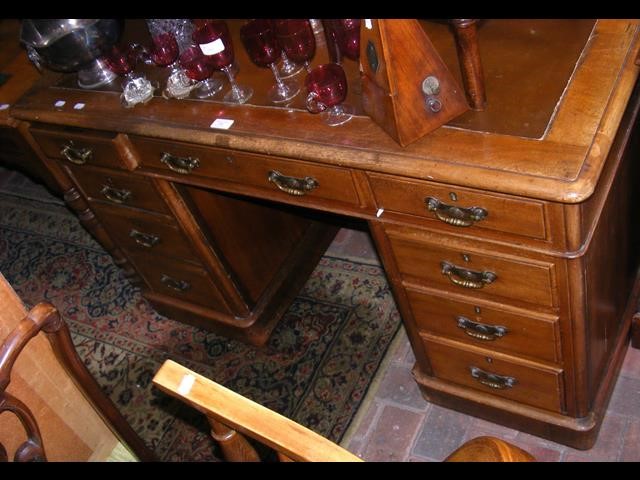 Antique pedestal desk with nine drawers to the fro