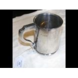 A silver tankard - 11.5cm high