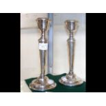A pair of silver candlesticks - 23cm high