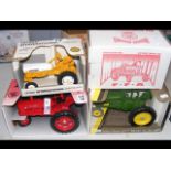 An Ertl die-cast tractor, together with three