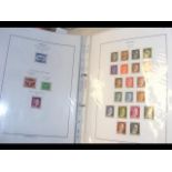 An album containing a large collection of stamps f