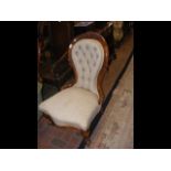 A Victorian button back easy chair with cabriole f