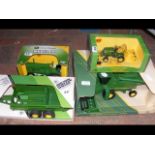 Four boxed models of John Deere farm equipment,