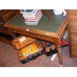 An antique two drawer desk on bobbin supports