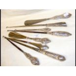 Silver handled shoe horns, button hooks, etc.