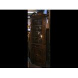 A 19th century marquetry corner cabinet with astra